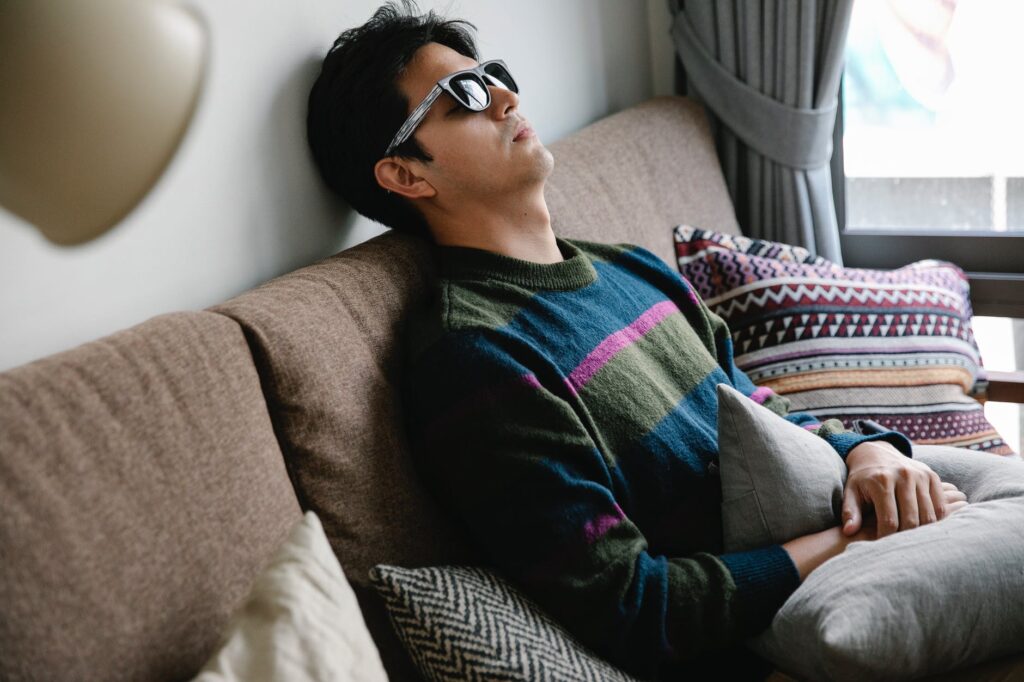 photo of man resting on couch